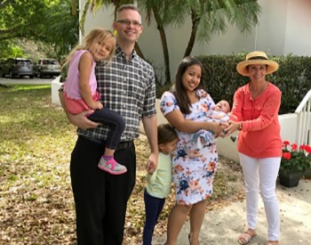 Family With New Baby Outside St. Margaret of Scotland Episcopal Church